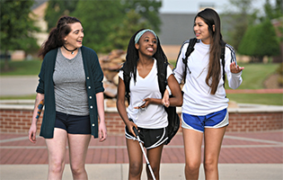 Three Students Walking Outside