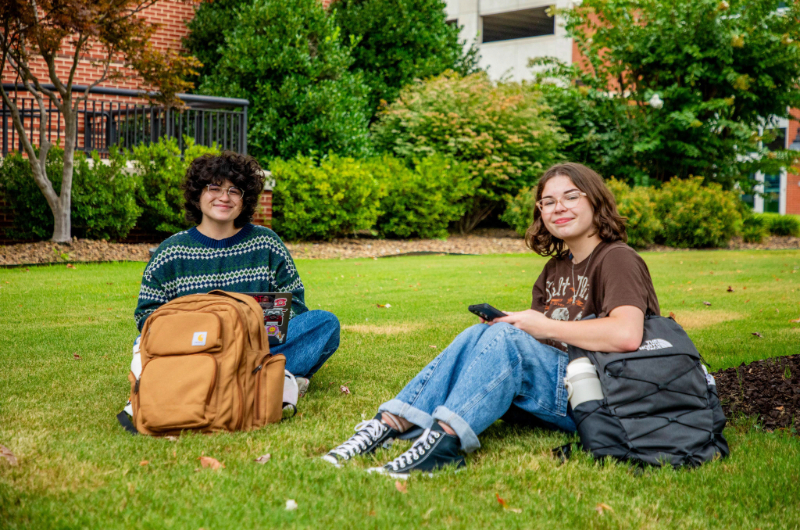 Two NWACC students studying in lawn. Two NWACC students studying in lawn.