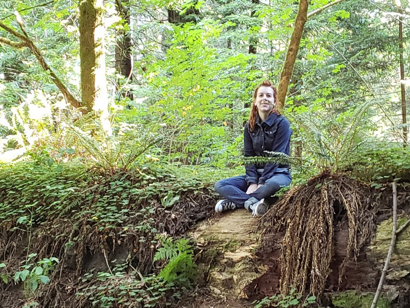 michelle seated in the woods