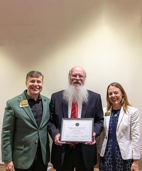 Image of NWACC Faculty Receiving Award (In photo from left to right: Dr. Dennis C. Rittle, Professor Curtis Harrell and Dr. Jennifer Swartout) 